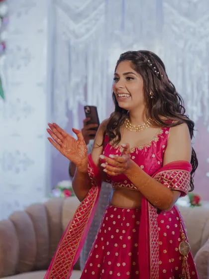 A candid moment of her clapping and enjoying the performances.