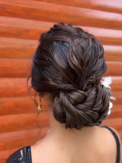 A closer look at the interwoven texture of this low bun, a technique we practice in the advanced module.