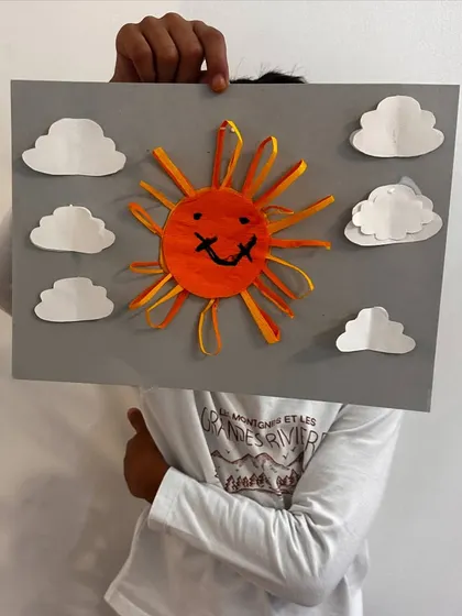 Another creative take on the sun craft, this one with a big smile and a sky full of clouds.