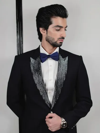 This tuxedo is all about making a refined statement. The shimmering lapels catch the light, creating a look that is both glamorous and masculine, perfect for a red carpet or New Year's Eve event.