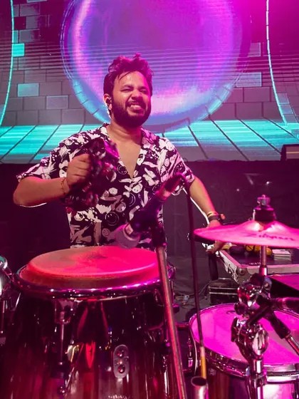 A close-up shot from a concert in Mumbai. I'm playing the congas and a cymbal, adding texture and rhythm to the band's sound.
