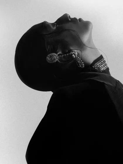 A black and white abstract portrait focusing on silhouette and form. The dramatic angle and lighting create a powerful, artistic statement.