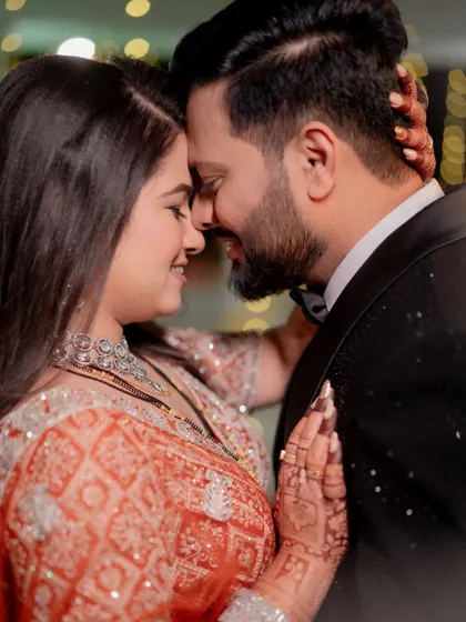 A tight close-up shot capturing the intimacy and emotion between the bride and groom during a slow dance at their reception.