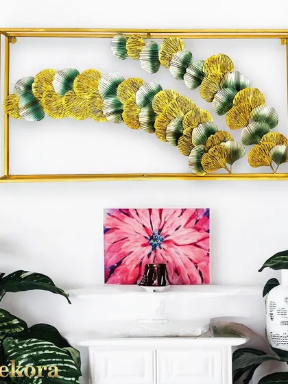 A framed wall art piece featuring a double row of ginkgo leaves, creating a sense of lushness and modern design.