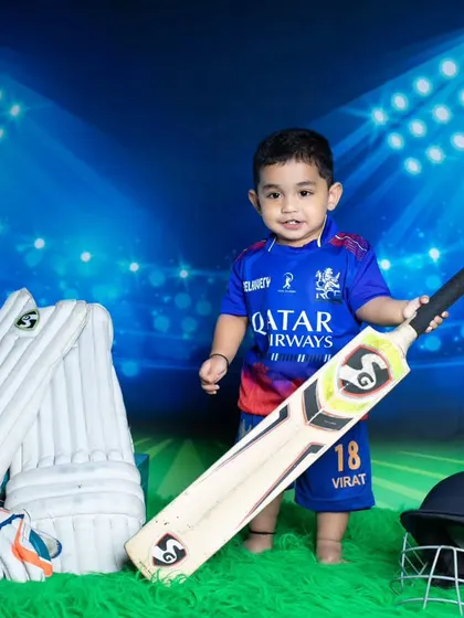 Our future Virat Kohli is ready to hit a six, posing confidently with his cricket bat.