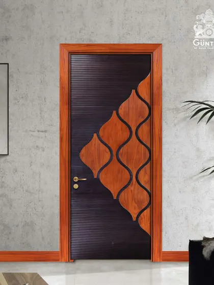 This designer door showcases a creative inlay pattern, where curved wood pieces are set against a dark, textured base. It's a playful yet sophisticated design that acts as a piece of art.