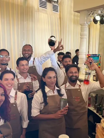 Our team of expert bartenders at a brunch event, showcasing their coordinated and stylish uniforms.