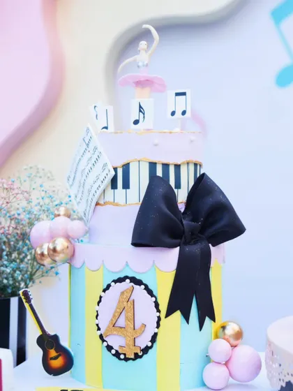 The centerpiece of the dessert table was this incredible music-themed cake, complete with a ballerina topper, piano keys, and musical notes, perfectly capturing the party's playful elegance.