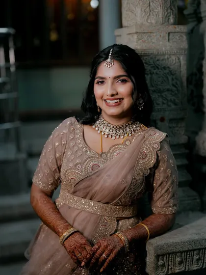 Vindya's reception look, featuring a beautiful smile. The makeup is designed to look just as good at the end of the night as it did at the beginning.