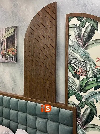 A close-up view of the custom headboard's botanical print and wood paneling, highlighting the quality of the materials and craftsmanship.