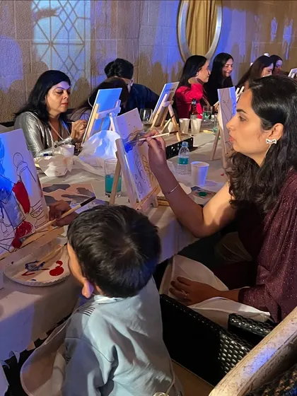 A mother and son painting together at the Birkenstock event. Our activities are designed to be enjoyable for all ages.