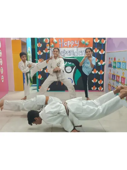 Our young warriors are a testament to the fact that discipline and strength have no age limit. This image captures our students demonstrating advanced bodyweight control and kicking techniques during a group session.