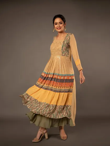 A joyful, twirling shot of a model in a multi-layered Anarkali dress. This captures the movement and flow of the fabric, perfect for a fun and festive collection.