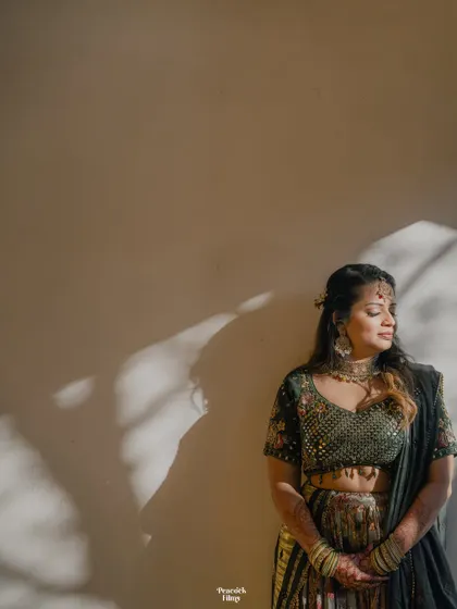 A beautiful solo portrait of the bride during her Mehendi ceremony, with artistic shadows creating a contemplative and serene mood.