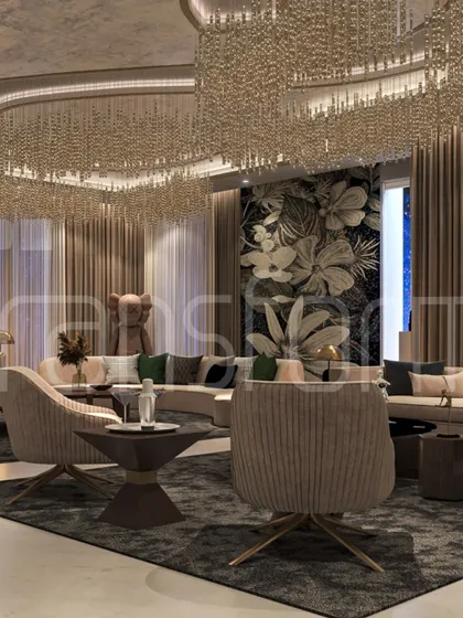 A living space designed for timelessness. The massive, cascading chandelier serves as the room's centerpiece, complemented by a floral accent wall and plush, curved seating that invites conversation and relaxation.