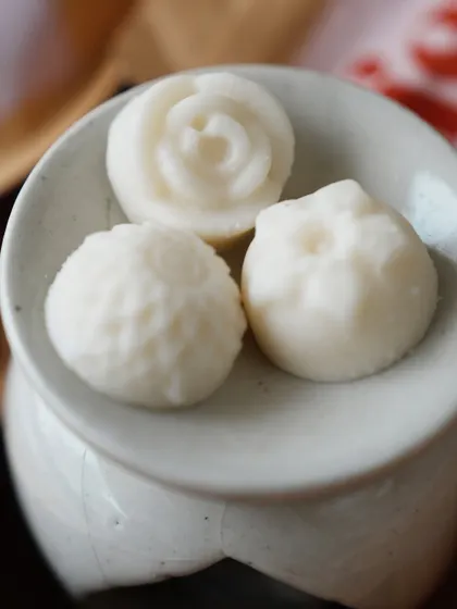 A close-up of our flower-shaped wax melts on a ceramic diffuser. The detail on these little melts is just adorable.