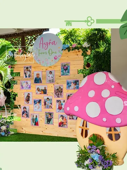 A personalized photo wall celebrating Ayra's first year, set within her Alice in Wonderland party. It's a heartwarming way to share memories with guests.