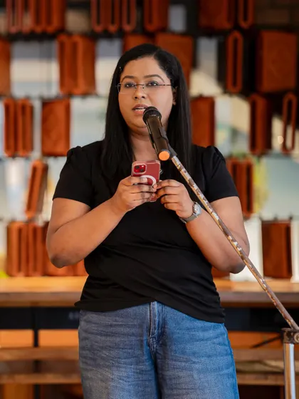 A performer reads her poem from her phone, a common sight at our modern poetry meetups. We believe poetry can be found anywhere, and our stage is open to all forms of expression.