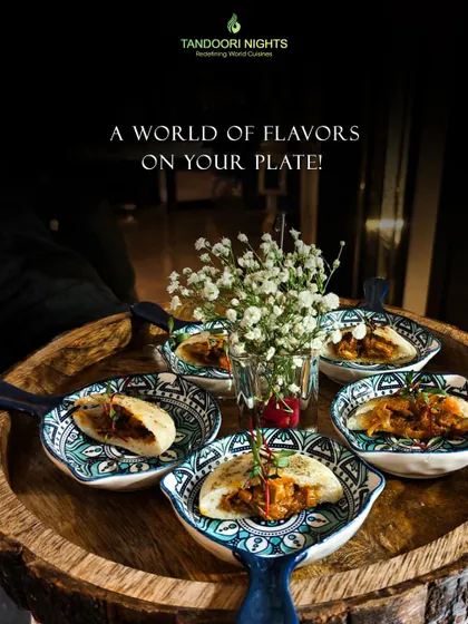 A world of flavors on your plate. This image captures our individually portioned dishes served in beautiful, patterned ceramic bowls on a wooden platter.