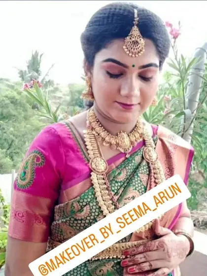 A closer look at the makeup for this baby shower. The eyeshadow tones are chosen to complement her green and pink saree, creating a harmonious and traditional look.