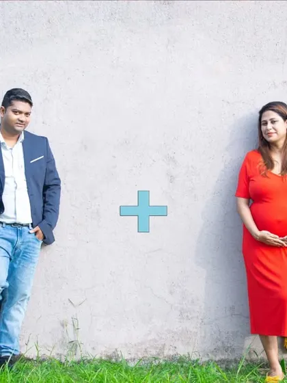 A creative and minimalist maternity announcement photo. The simple equation '1 + 1 = 3' against a plain wall tells a powerful and exciting story.