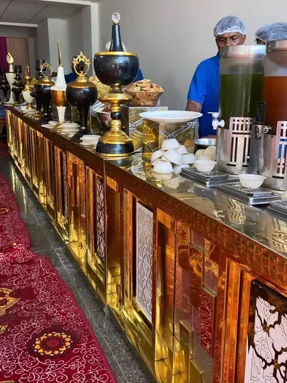 For grand weddings and corporate events, we bring out the best. This elegant golden buffet counter setup shows how we can scale our services for any event size without losing that personal touch.