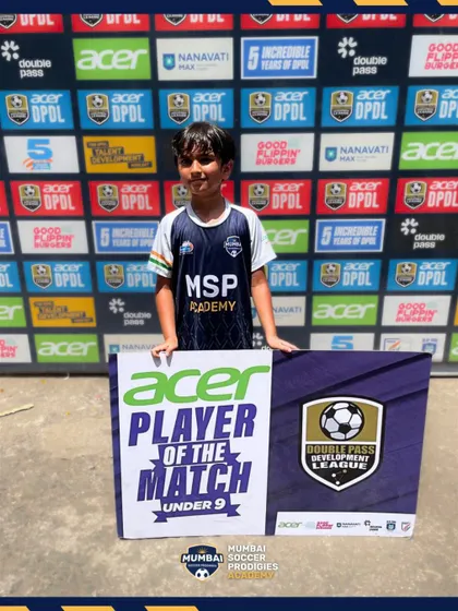 A U9 player proudly displays his Player of the Match award.