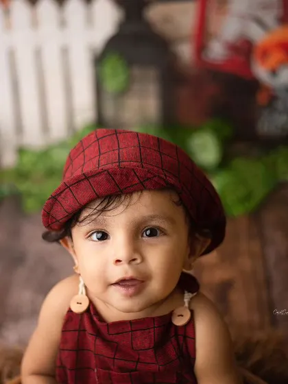 A heartbreaker in the making. This little man is looking right at the camera with his big, beautiful eyes in his cute rustic outfit.