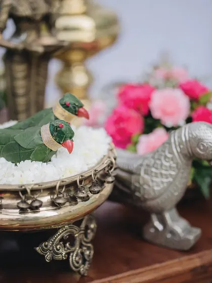 A close-up of the playful parrot accents, nestled in a traditional brass bowl filled with jasmine. These small, handcrafted details are a testament to our meticulous craftsmanship and our passion for personalization.