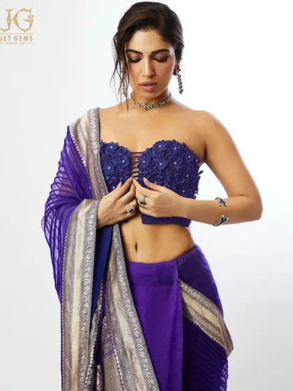Bhumi Pednekar adjusts her sari, giving a glimpse of the sapphire ring and unique silver cuff that add a modern edge to her look.