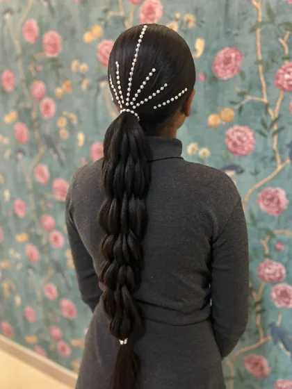 A sleek and modern take on a bubble braid, with pearl embellishments creating a starburst effect at the top.