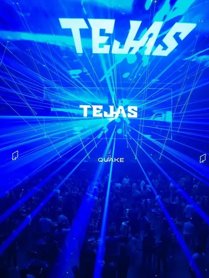 A stunning shot of the blue laser grid filling the entire space at Quake in Hyderabad, with my name on the screen.