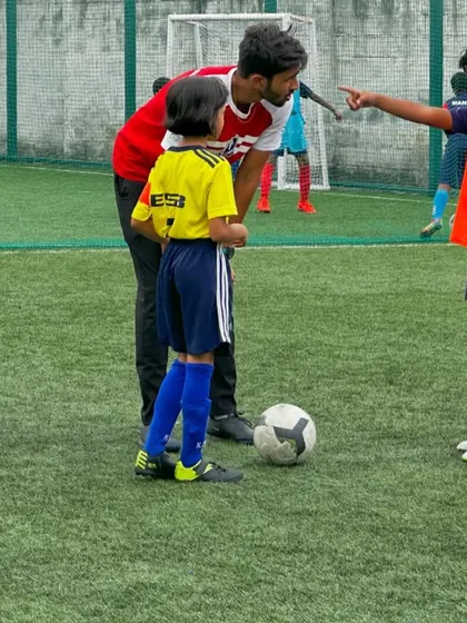 A coach gives instructions to a player during a break in the Samurai Cup final.