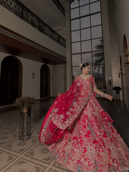 Another angle of the bride's happy twirl, capturing the grace and beauty of her traditional attire against the modern architecture.