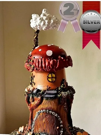A view of my award-winning mushroom house cake, showing the silver medal recognition. This cake is a testament to what can be achieved with whipped cream as an artistic medium.