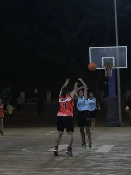 Intense action under the basket during a women's semi-final game. Both teams are fighting hard for a spot in the finals.