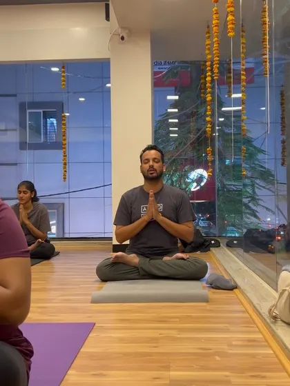 A student finds a moment of peace and focus in Padmasana (Lotus Pose) during our class.