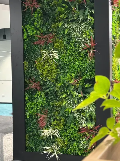 A detailed shot showing the lifelike quality of the artificial plants used in the vertical garden. I select high-quality materials to ensure a realistic and lasting finish.