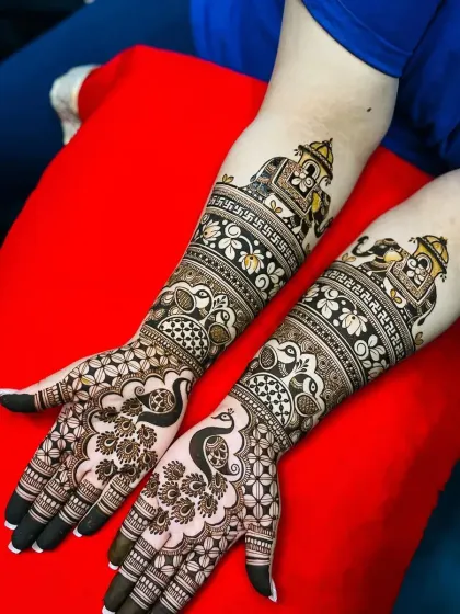 A close-up of the elephant and peacock motifs, showing the fine details and shading.