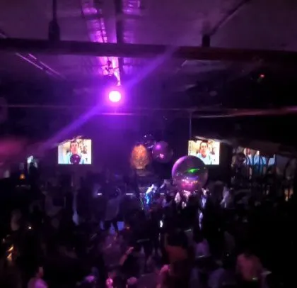 A corporate event for Tredence in a club-like setting with a disco ball and purple lights.
