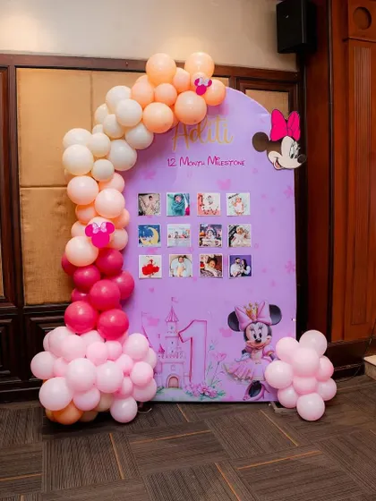 A personalized milestone board for a Minnie Mouse themed party. It's a wonderful way to showcase the baby's first year journey for all the guests to see.