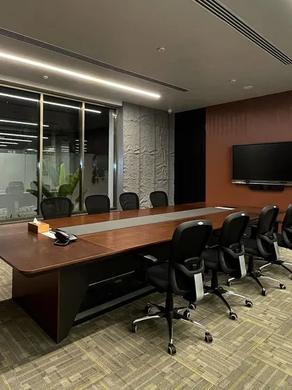 A duplicate image of the VEE CEE EXPORTS conference room, highlighting the long wooden table and ergonomic seating.