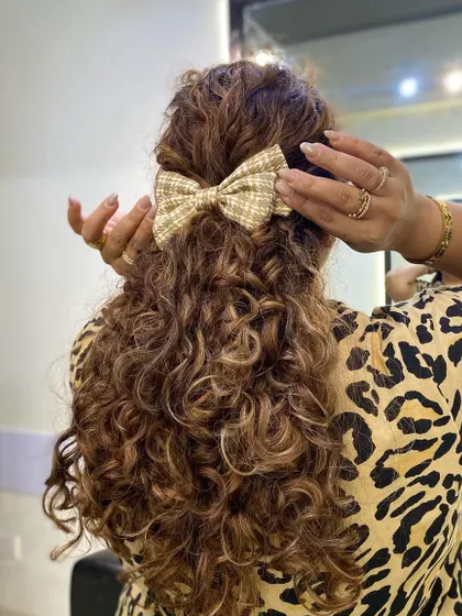 Showing how to place a hair accessory without disrupting your curl pattern.