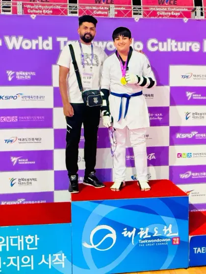 On the winner's podium with my student at the 18th World Taekwondo Culture Expo.