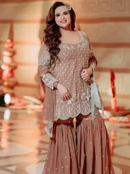 I loved styling my friend for her nephew's Namkaran ceremony. We chose this elegant dusty rose sharara set with intricate silver embroidery. It's a perfect example of styling for family functions, ensuring you look festive and chic.