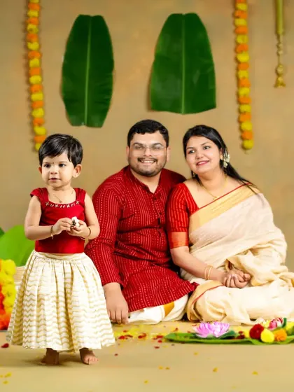 A happy Onam to all! This family looks wonderful in their traditional attire, surrounded by flowers and festive decorations for this special portrait.