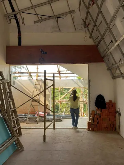 An interior room at the Kolgaon project during construction. This photo shows the raw state of the building, with exposed ceiling framework and brick walls, highlighting the core materials before finishing.
