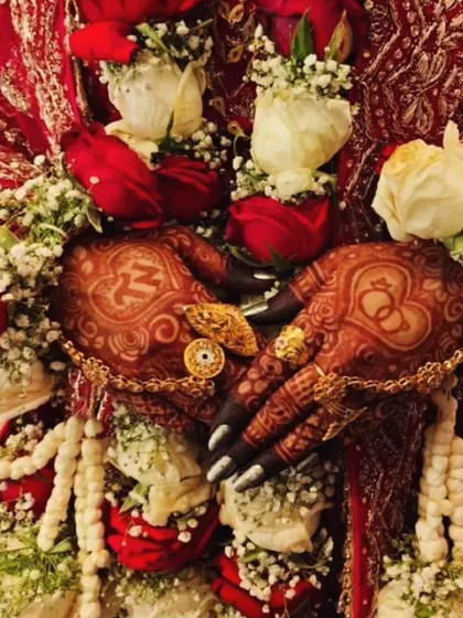 A close-up of the bride's hands during the ceremony, showing the personalized ring and initial design with its beautiful dark color.