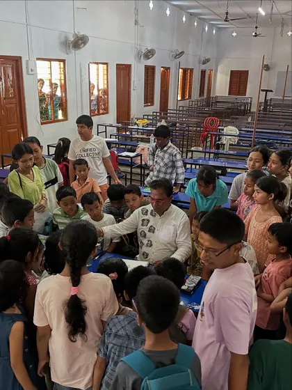 I am surrounded by curious students at the Gogamukh College workshop as I demonstrate a drawing technique. This kind of close interaction is what makes in-person classes so special.