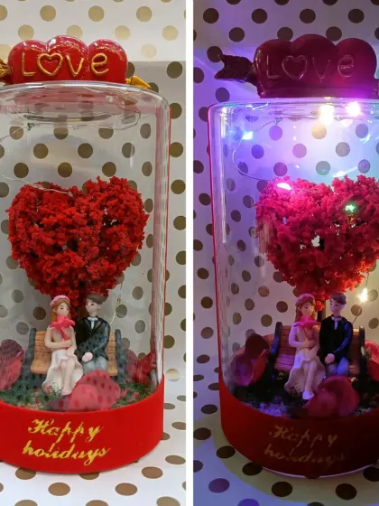 A perfect Valentine's Day gift. This glass dome contains a couple on a bench under a heart-shaped tree, with LED lights to make it sparkle.